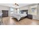Spacious primary bedroom featuring wood-look floors, a ceiling fan, and neutral tones for a calming retreat at 3841 E Jasper Dr, Gilbert, AZ 85296