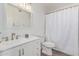 Bright bathroom features a modern vanity, recessed lighting, and a shower with curtain at 4128 E Coolbrook Ave, Phoenix, AZ 85032