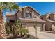 Charming two-story home featuring a desert landscape, two car garage and a terracotta tile roof at 4128 E Coolbrook Ave, Phoenix, AZ 85032