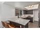 Kitchen featuring a breakfast bar with seating, stainless steel appliances and a window for natural lighting at 4128 E Coolbrook Ave, Phoenix, AZ 85032