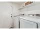 Functional laundry room with modern washer and dryer, and a storage shelf at 4128 E Coolbrook Ave, Phoenix, AZ 85032