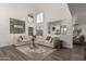 Bright living room with vaulted ceilings, neutral color palette, hardwood floors, and modern furniture at 4128 E Coolbrook Ave, Phoenix, AZ 85032