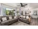 Bright living room with hardwood floors, neutral color palette, and large glass doors to the backyard at 4128 E Coolbrook Ave, Phoenix, AZ 85032