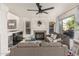 Comfortable living room with fireplace, hardwood floors, neutral color palette, and a view to the backyard at 4128 E Coolbrook Ave, Phoenix, AZ 85032