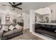 Cozy living room with hardwood floors, neutral color palette, fireplace, and a dining area nearby at 4128 E Coolbrook Ave, Phoenix, AZ 85032