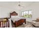 Main bedroom featuring ornate dark wood furnishings, a ceiling fan, neutral decor and a window for natural light at 4128 E Coolbrook Ave, Phoenix, AZ 85032
