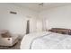 Bright main bedroom featuring a ceiling fan, a reading chair and views to the ensuite bathroom at 4128 E Coolbrook Ave, Phoenix, AZ 85032