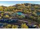 Aerial view of community pool area and nearby homes nestled within lush desert landscape at 41817 N Bridlewood Way, Phoenix, AZ 85086