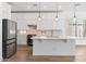 Well-lit kitchen features a center island, stainless steel appliances, and custom white cabinets at 41817 N Bridlewood Way, Phoenix, AZ 85086