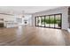 Bright, open-concept living area featuring hardwood floors, a fireplace, and sliding doors to a patio at 41817 N Bridlewood Way, Phoenix, AZ 85086
