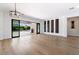Spacious living room with hardwood floors, sliding glass doors to the backyard, and wine storage at 41817 N Bridlewood Way, Phoenix, AZ 85086