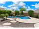 Backyard pool area showcasing decorative stone accents and mature landscaping at 41817 N Bridlewood Way, Phoenix, AZ 85086