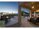 Inviting covered patio offers shaded lounge seating and dining with a beautiful desert landscape and pool view at 4632 S Alamos Way, Gold Canyon, AZ 85118