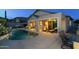 Beautiful backyard featuring a sparkling pool, covered patio, outdoor kitchen, and lounge seating at 4632 S Alamos Way, Gold Canyon, AZ 85118