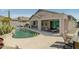 Beautiful backyard featuring a sparkling pool, covered patio, outdoor kitchen, and lounge seating at 4632 S Alamos Way, Gold Canyon, AZ 85118