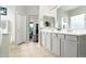 Well-lit bathroom with a double vanity, neutral countertops, and a view to the bedroom's sitting area at 4632 S Alamos Way, Gold Canyon, AZ 85118