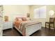 Comfortable bedroom with a queen-size bed, hardwood floors, and a light-filled window at 4632 S Alamos Way, Gold Canyon, AZ 85118