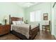 Inviting bedroom with a wooden bed frame, a bedside table, and a relaxing green color scheme at 4632 S Alamos Way, Gold Canyon, AZ 85118