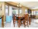 Bright dining area with wood table, chandelier lighting, and sliding glass doors leading to the outdoors at 4632 S Alamos Way, Gold Canyon, AZ 85118