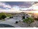 Desert home features a three-car garage, manicured landscaping and a gorgeous sunset at 4632 S Alamos Way, Gold Canyon, AZ 85118