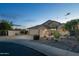 Spacious home boasts a three-car garage, desert landscaping and attractive curb appeal at 4632 S Alamos Way, Gold Canyon, AZ 85118