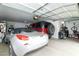 Spacious garage featuring two cars, a tool bench, storage cabinets, and bicycle rack at 4632 S Alamos Way, Gold Canyon, AZ 85118