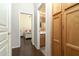 Hallway with wood flooring leading to a bedroom and bathroom, highlighted by a linen closet at 4632 S Alamos Way, Gold Canyon, AZ 85118