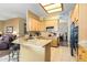 Kitchen with breakfast bar seating and a view of the living room, perfect for casual dining and entertaining at 4632 S Alamos Way, Gold Canyon, AZ 85118