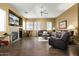 Spacious living room with fireplace and ample seating, perfect for entertaining and relaxation at 4632 S Alamos Way, Gold Canyon, AZ 85118