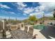 Covered patio includes a dining table and chairs with stunning desert views at 4632 S Alamos Way, Gold Canyon, AZ 85118