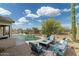 Backyard offers a serene pool, covered patio, barbecue, and desert views at 4632 S Alamos Way, Gold Canyon, AZ 85118