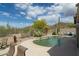 Gorgeous pool area features a desert landscape, stone accents, and seating at 4632 S Alamos Way, Gold Canyon, AZ 85118