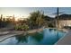 Inviting pool area showcases desert landscaping, rock waterfall and mountain views at 4632 S Alamos Way, Gold Canyon, AZ 85118