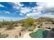 Inviting backyard pool features desert landscaping and mountain views in a serene setting at 4632 S Alamos Way, Gold Canyon, AZ 85118