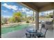 Desert backyard with a pool, small waterfalls, barbecue area, lounge seating, and mountain views at 4632 S Alamos Way, Gold Canyon, AZ 85118