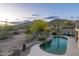 Beautiful backyard pool with desert scenery, mountains, and a seating area at 4632 S Alamos Way, Gold Canyon, AZ 85118