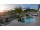 Scenic backyard oasis with a sparkling pool, desert landscaping, small water fall and lounge seating at 4632 S Alamos Way, Gold Canyon, AZ 85118