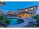 Backyard features a pool, patio and lush landscaping against the backdrop of the home's exterior at 4894 E Palm Beach Dr, Chandler, AZ 85249