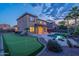 Backyard features a pool, putting green, covered patio and professional landscaping at 4894 E Palm Beach Dr, Chandler, AZ 85249