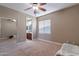 Bedroom featuring a ceiling fan, closet with sliding mirrored doors and view to bathroom at 4894 E Palm Beach Dr, Chandler, AZ 85249