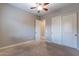 Cozy bedroom features ceiling fan and carpeted floors with closet at 4894 E Palm Beach Dr, Chandler, AZ 85249