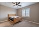 Bedroom with neutral walls, plush carpet, natural wood bed frame and bright window at 4894 E Palm Beach Dr, Chandler, AZ 85249