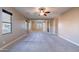 Large bedroom with comfortable carpeting, a ceiling fan, and multiple windows for natural light at 4894 E Palm Beach Dr, Chandler, AZ 85249