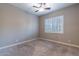 Neutral bedroom featuring a ceiling fan, carpeted floors, and large shuttered windows at 4894 E Palm Beach Dr, Chandler, AZ 85249