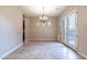 Inviting dining room with tile floors, stylish chandelier, and French doors opening to the backyard at 4894 E Palm Beach Dr, Chandler, AZ 85249