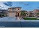 Inviting two-story home showcasing a well-manicured lawn and a two-car garage at dusk at 4894 E Palm Beach Dr, Chandler, AZ 85249