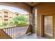 Balcony with view of community, stone pillars, metal railing, and a tiled floor at 5350 E Deer Valley Dr # 2435, Phoenix, AZ 85054
