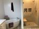 Modern bathroom featuring a soaking tub and separate glass enclosed shower with built-in shelves at 5350 E Deer Valley Dr # 2435, Phoenix, AZ 85054