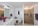 Bathroom showcasing a standalone tub and glass-enclosed shower with a bench and decorative niches at 5350 E Deer Valley Dr # 2435, Phoenix, AZ 85054
