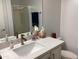 Bathroom vanity with granite countertop, single sink, bronze faucet and mirror reflecting shower stall at 5350 E Deer Valley Dr # 2435, Phoenix, AZ 85054